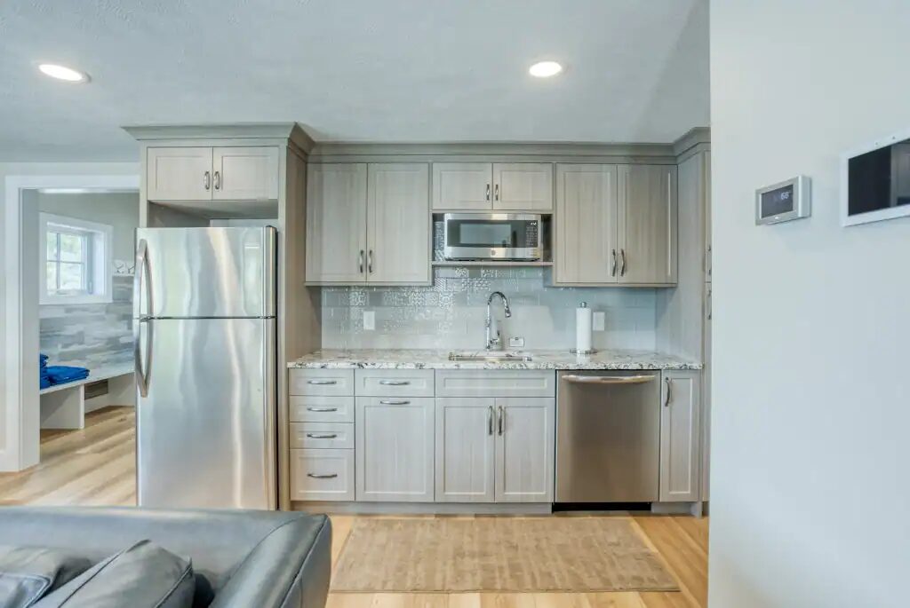 A kitchenette on the lower level with a full-height fridge, microwave, sink and dishwasher.